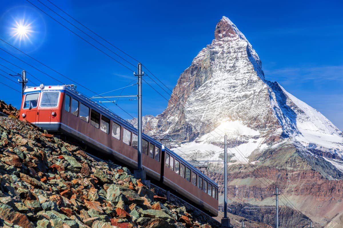 Gornergrat Bahn erklimmt mit dem Matterhorn im Rücken einen steinigen Berg