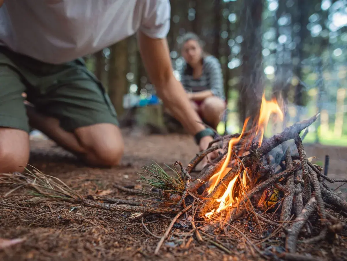 Linda macht Feuer im Wald beim Survival Training, einem super Geschenk für Naturliebhaber