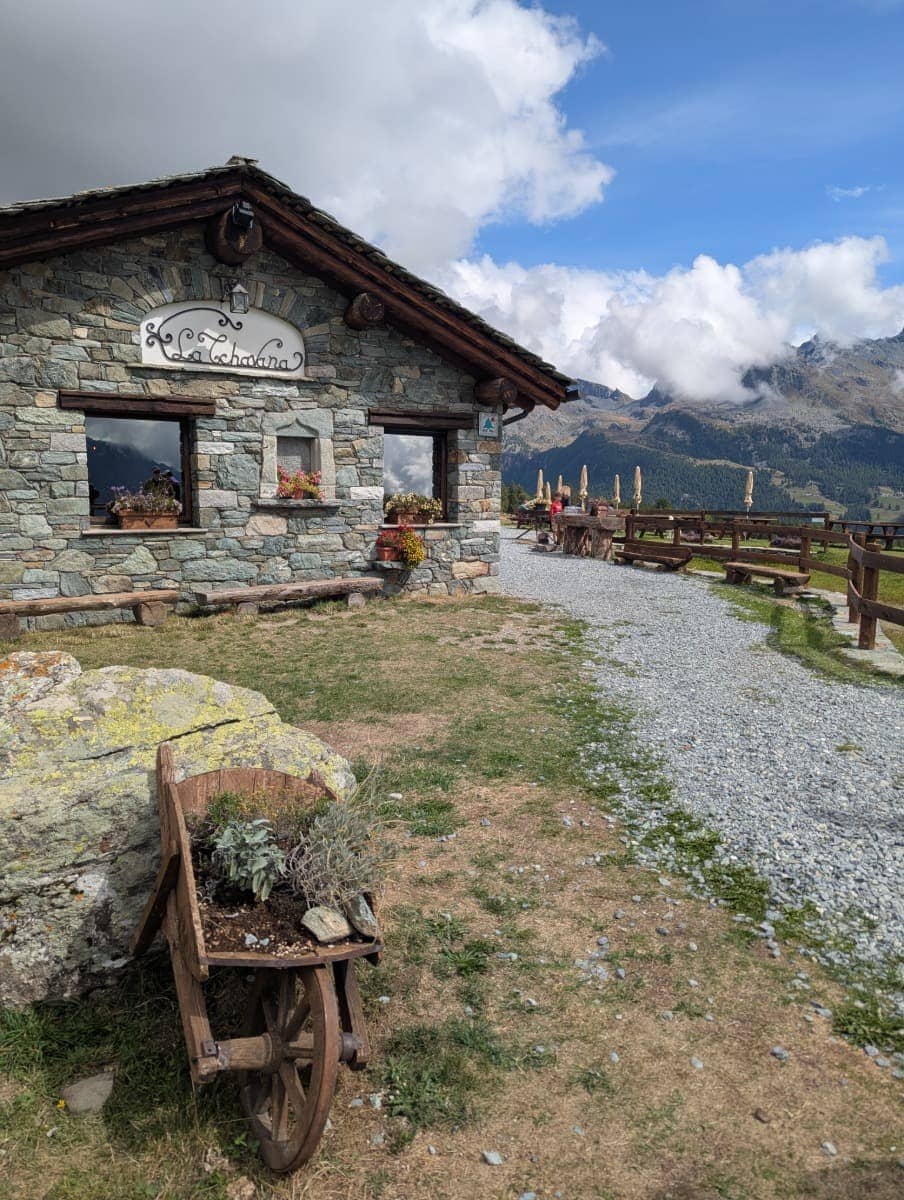 Die urige Almhütte La Tchavana im Val d'Ayas lädt mit rustikalem Charme und Bergpanorama zur Einkehr ein. Hier verbindet sich Kulinarik mit alpiner Tradition.