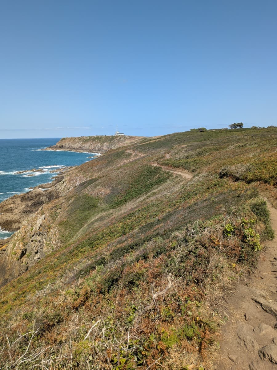 Der schmale Küstenwanderweg GR34 schlängelt sich über die Steilküste zum Pointe du Grouin mit weitem Blick auf das Meer und die zerklüftete Küste der Bretagne.